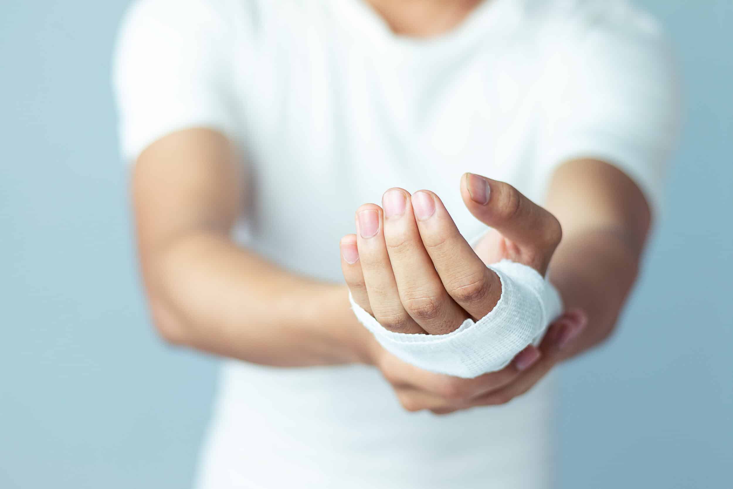 A close-up shot of a person’s hand with a bandage wrapped around it